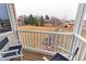 Spacious balcony with chairs offers views of the backyard and surrounding neighborhood at 7208 Secrest Ct, Arvada, CO 80007
