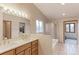 Well-lit bathroom featuring a double sink vanity, a large mirror, and a glass-enclosed shower at 7208 Secrest Ct, Arvada, CO 80007