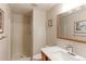 Clean bathroom featuring shower stall, single vanity, and updated fixtures at 7208 Secrest Ct, Arvada, CO 80007