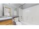Full bathroom with a shower and tub combination, updated fixtures, and tiled flooring at 7208 Secrest Ct, Arvada, CO 80007