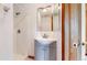 Bathroom with a walk-in shower, updated fixtures, and a modern vanity at 7208 Secrest Ct, Arvada, CO 80007