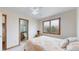 Comfortable bedroom with a ceiling fan, a window, and an attached bathroom at 7208 Secrest Ct, Arvada, CO 80007