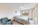 Bedroom with a large window, cozy chair, and a comfortable bed, offering a relaxing atmosphere at 7208 Secrest Ct, Arvada, CO 80007