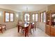 Dining room boasts a wood table, six chairs, ample natural light, and stylish decor at 7208 Secrest Ct, Arvada, CO 80007