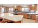 Modern kitchen with stainless steel appliances, quartz countertops, tile backsplash, and plentiful storage at 7208 Secrest Ct, Arvada, CO 80007