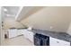 Tidy laundry room with washer, dryer, sink, and under-counter storage at 7208 Secrest Ct, Arvada, CO 80007