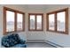 Bright living space featuring a bay window with wood trim, a cozy chair, and natural light at 7208 Secrest Ct, Arvada, CO 80007