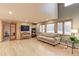 Bright living room with hardwood floors, a large sofa, and ample natural light at 7208 Secrest Ct, Arvada, CO 80007