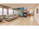 Inviting living room features a cozy fireplace and large windows for natural light at 7208 Secrest Ct, Arvada, CO 80007