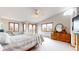 Spacious main bedroom with sitting area, ample natural light and private balcony at 7208 Secrest Ct, Arvada, CO 80007