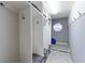 Spacious mud room with individual locker-style storage, bench, and tile floor at 7208 Secrest Ct, Arvada, CO 80007