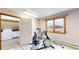 Well-lit workout room with exercise bike, window, and view to the backyard at 7208 Secrest Ct, Arvada, CO 80007