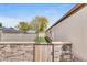 Fenced-in backyard with stone and wood fence, and small grassy area at 8426 Cook Way, Denver, CO 80229