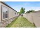 Backyard featuring a grassy area, partial fencing, and a view of the home's exterior at 8426 Cook Way, Denver, CO 80229