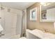Bathroom featuring a shower-tub combination with tiled walls and a framed mirror above the sink at 8426 Cook Way, Denver, CO 80229
