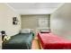Bedroom showcasing two beds, a window, and neutral-painted walls complemented by hardwood floors at 8426 Cook Way, Denver, CO 80229