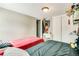 Bedroom featuring two beds, a closet, and a small vanity with neutral-painted walls and light-colored flooring at 8426 Cook Way, Denver, CO 80229