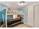 Cozy bedroom featuring a white bunk bed with light blue walls and neutral color flooring at 8426 Cook Way, Denver, CO 80229