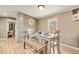 Dining area with gray wood table, bench seating, and modern lighting at 8426 Cook Way, Denver, CO 80229