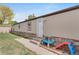 Home exterior with stone accents, white door, steps, and small play area on a grassy lawn at 8426 Cook Way, Denver, CO 80229