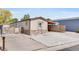 Single story home with stone accents, paved driveway, and attached carport at 8426 Cook Way, Denver, CO 80229