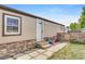 Exterior showcasing stone accents, white front door, and a small play area next to a gate at 8426 Cook Way, Denver, CO 80229