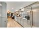 Spacious kitchen featuring stainless steel refrigerator, modern appliances and wood flooring at 8426 Cook Way, Denver, CO 80229