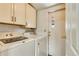Laundry room featuring white cabinets, a washer, and dryer with an exterior door for convenience at 8426 Cook Way, Denver, CO 80229