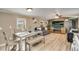 Living room and dining area features wood grain floors and lots of natural light at 8426 Cook Way, Denver, CO 80229