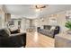 Open concept living room, kitchen, and dining area with wood grain floors at 8426 Cook Way, Denver, CO 80229
