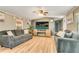 Comfortable living room with wood grain floors, ceiling fan, and entertainment center at 8426 Cook Way, Denver, CO 80229