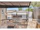 Outdoor patio featuring a built-in grill, dining area, pergola and a storage shed at 8426 Cook Way, Denver, CO 80229