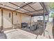 Outdoor patio space featuring a grill, dining set, a pergola and brick flooring at 8426 Cook Way, Denver, CO 80229