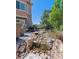 Tranquil backyard featuring a beautiful rock water feature and lush greenery at 6711 S Catawba Way, Aurora, CO 80016