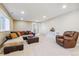 This basement features a sectional sofa, a recliner, and a console table at 6711 S Catawba Way, Aurora, CO 80016