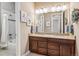Bright bathroom with double sink vanity, granite countertops, decorative lighting, and tiled shower/tub combo at 6711 S Catawba Way, Aurora, CO 80016