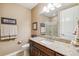 Bathroom with granite countertop, decorative mirror, and a glass shower enclosure at 6711 S Catawba Way, Aurora, CO 80016