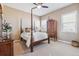 Bedroom with a four-poster bed, wooden furniture, a ceiling fan, and two windows providing natural light at 6711 S Catawba Way, Aurora, CO 80016