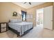 Comfortable bedroom with neutral walls, a ceiling fan, and a view of an adjoining seating area at 6711 S Catawba Way, Aurora, CO 80016