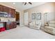 Cozy bonus room featuring a kitchenette with dark wood cabinets and a comfortable seating area at 6711 S Catawba Way, Aurora, CO 80016