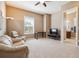 Bonus room with seating area, desk, and view of an adjoining bathroom at 6711 S Catawba Way, Aurora, CO 80016