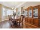 Formal dining room featuring hardwood floors, crown molding, and a large window at 6711 S Catawba Way, Aurora, CO 80016