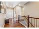 Welcoming hallway with hardwood floors, staircase, and a bench seat near the front door at 6711 S Catawba Way, Aurora, CO 80016