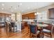 Open kitchen featuring a central island, seating, and views into the connected dining area at 6711 S Catawba Way, Aurora, CO 80016