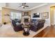 Cozy living room with a fireplace, plush seating, and a ceiling fan at 6711 S Catawba Way, Aurora, CO 80016