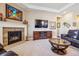 Comfortable living room with a stone fireplace, built-in media unit, and hardwood floors at 6711 S Catawba Way, Aurora, CO 80016