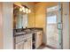 Modern bathroom with double vanity, granite countertop, wooden cabinets, and a walk-in shower at 280 Hess Ave, Golden, CO 80401