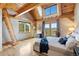 Well-lit bedroom featuring wood beams, vaulted ceiling, ladder, and private balcony with mountain views at 280 Hess Ave, Golden, CO 80401