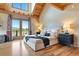 Bright bedroom with high vaulted ceilings, exposed wood beams, and a private balcony with mountain views at 280 Hess Ave, Golden, CO 80401