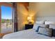 Close up of bedroom with large bed, stylish decor and a private balcony with mountain views at 280 Hess Ave, Golden, CO 80401